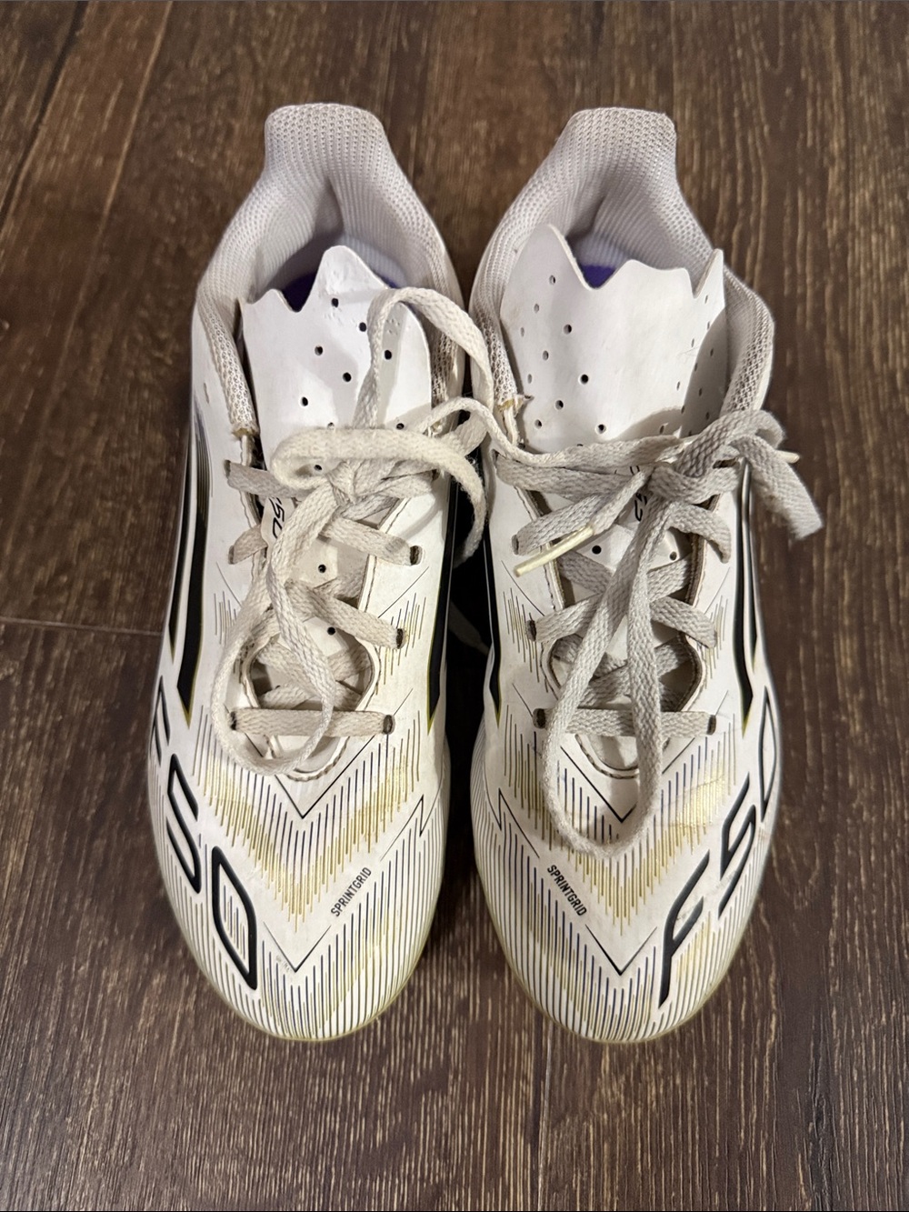 adidas White Soccer Cleats with Black & Gold Details